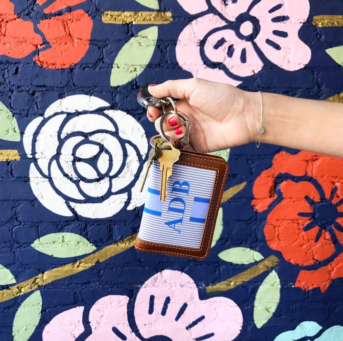 Colorful mural key ring wallet in hand
