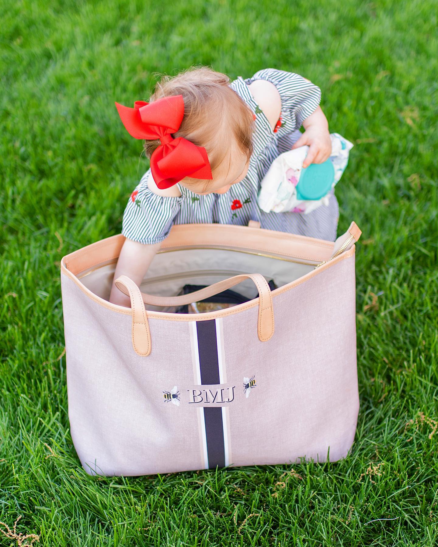 Stylish mom with a monogram diaper bag, the perfect accessory for modern parenting
