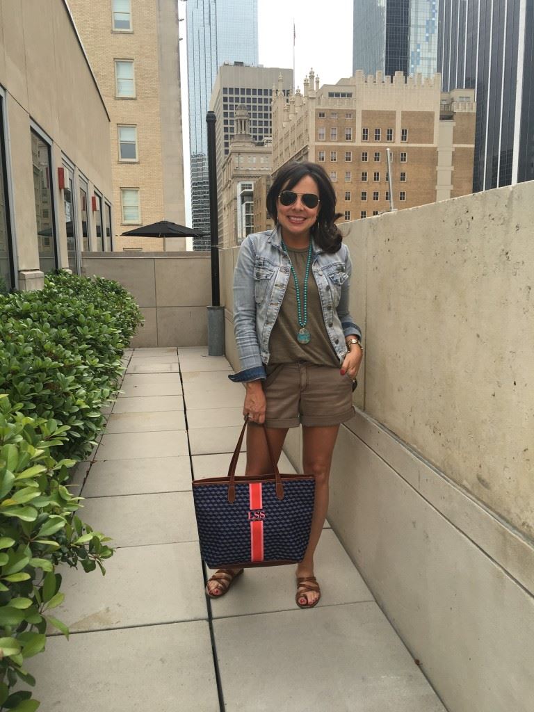 Fashionable woman on a city stroll with a chic monogram purse