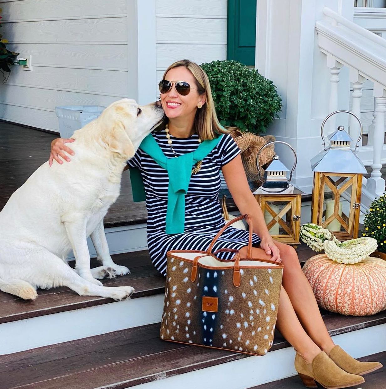 Relaxed autumn vibe with a woman in a striped dress and a dog, complemented by a unique personalized handbag