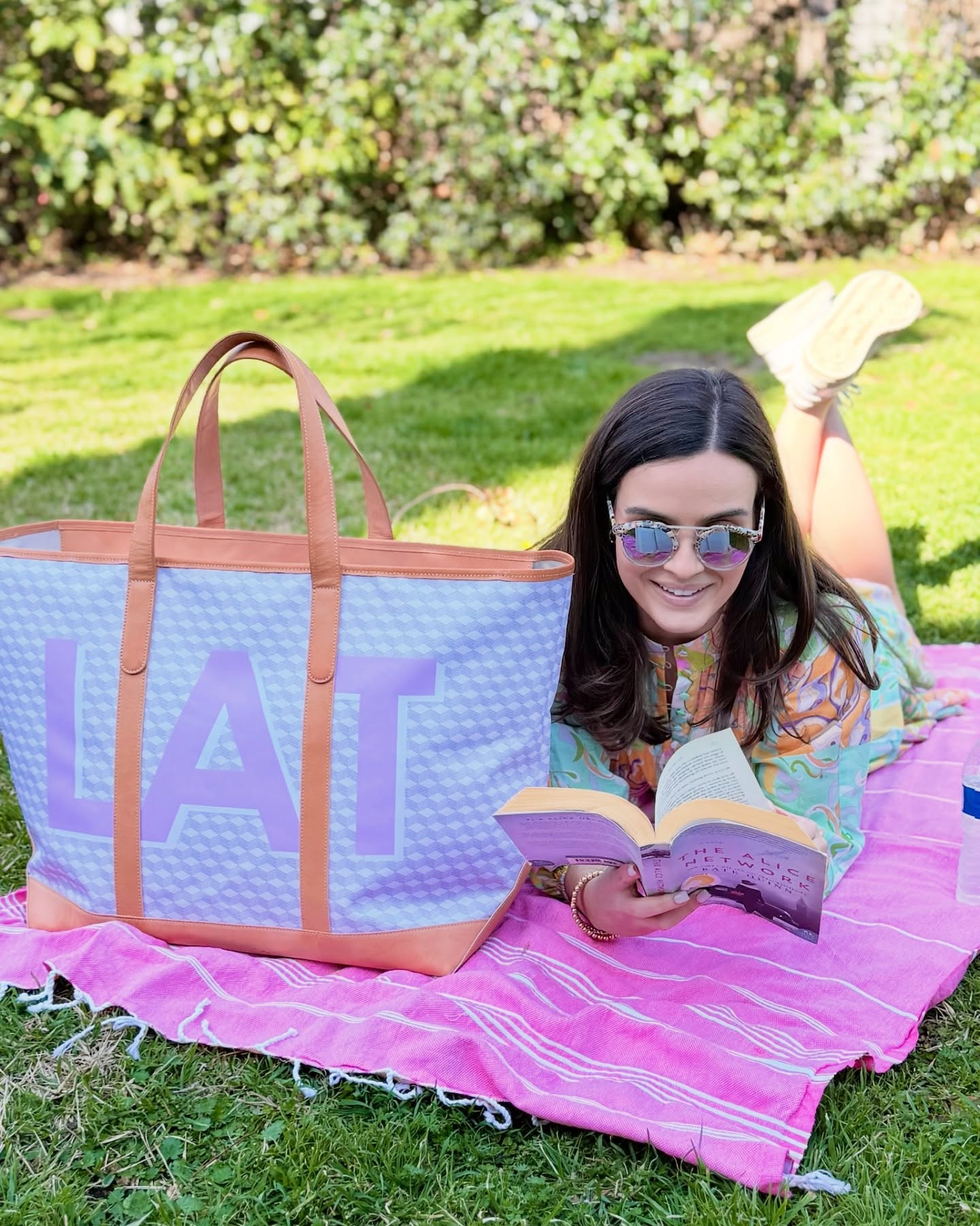Monogrammed Tote Bags 4 Woman enjoying a read outdoors with a personalized large monogrammed yacht tote bag, a type of monogrammed tote bag.